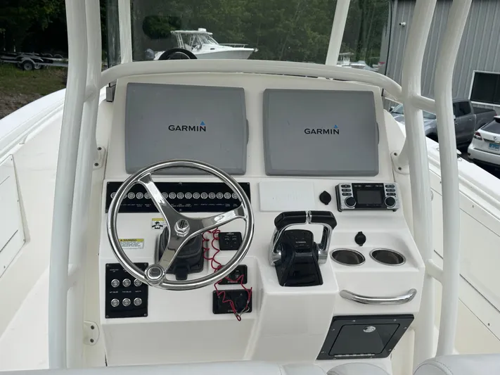  Yacht Photos Pics 2013 Edgewater 318CC boat dashboard with Garmin displays and steering wheel.
