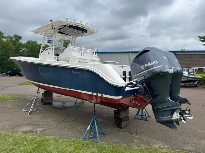 Yacht Photos Pics 2013 Edgewater 318CC boat with Yamaha engines on stands, displayed outdoors.