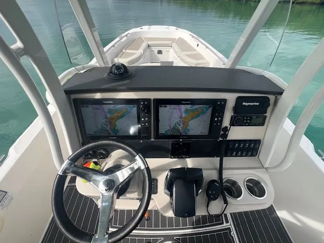  Yacht Photos Pics 2022 Boston Whaler DAUNTLESS helm with dual navigation screens and steering wheel.