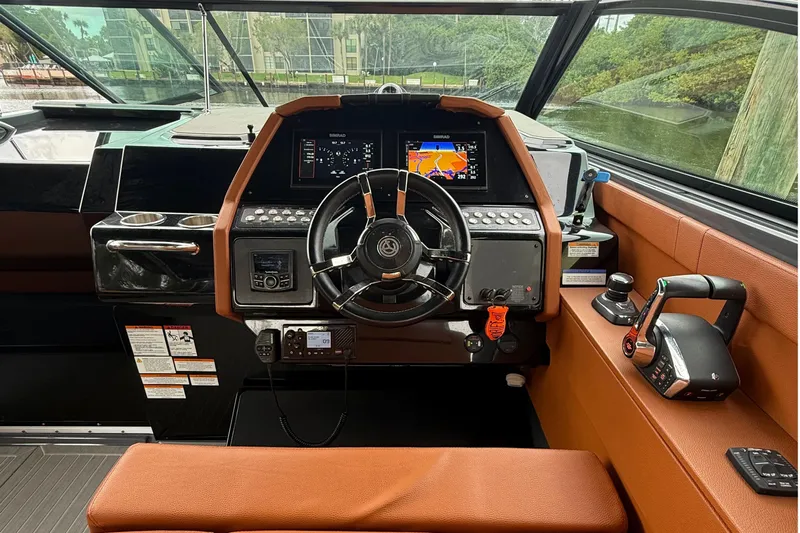 Kailani II Yacht Photos Pics 2023 Cruisers Yachts 34 GLS OB helm with modern controls and navigation displays.