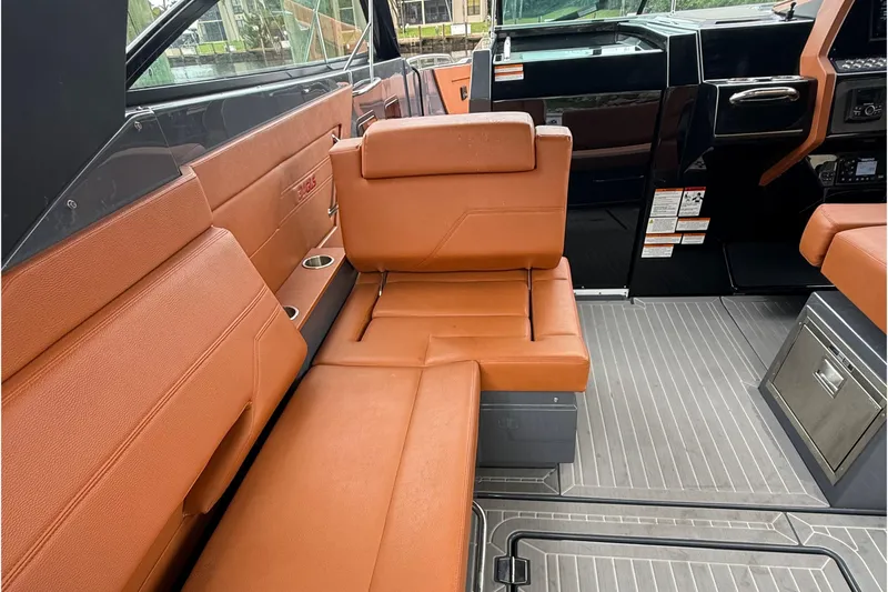 Kailani II Yacht Photos Pics 2023 Cruisers Yachts 34 GLS OB interior with brown leather seating and modern dashboard.