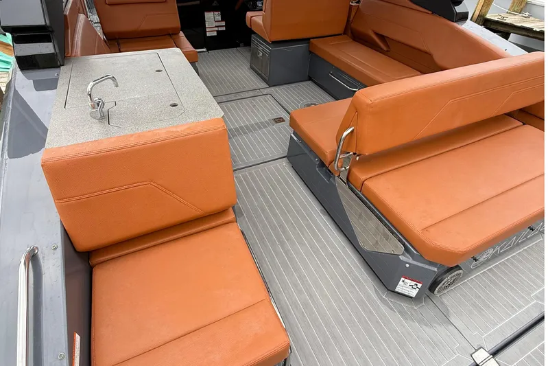 Kailani II Yacht Photos Pics 2023 Cruisers Yachts 34 GLS OB interior with orange seating and sleek design.