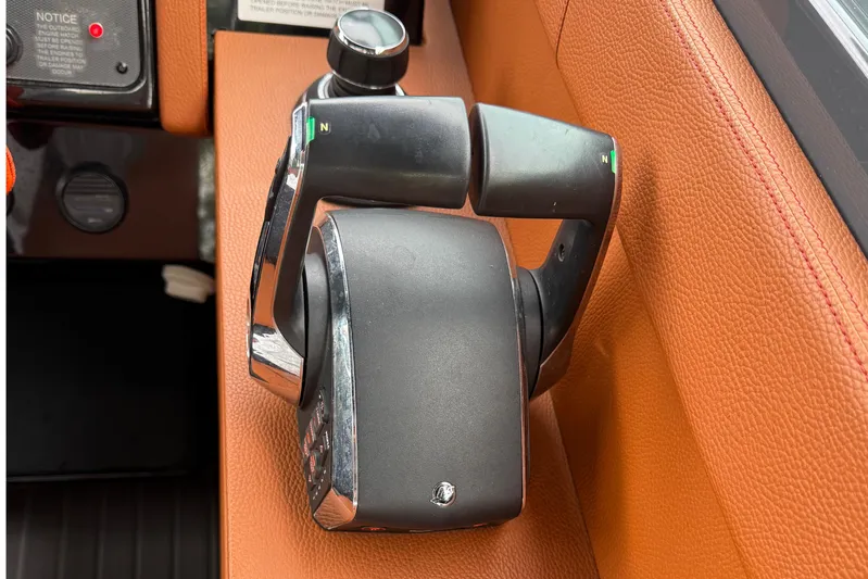 Kailani II Yacht Photos Pics Throttle control of 2023 Cruisers Yachts 34 GLS OB on brown leather panel.