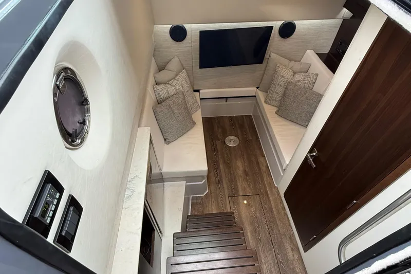 Kailani II Yacht Photos Pics 2023 Cruisers Yachts 34 GLS OB cabin interior with modern seating and wood flooring.