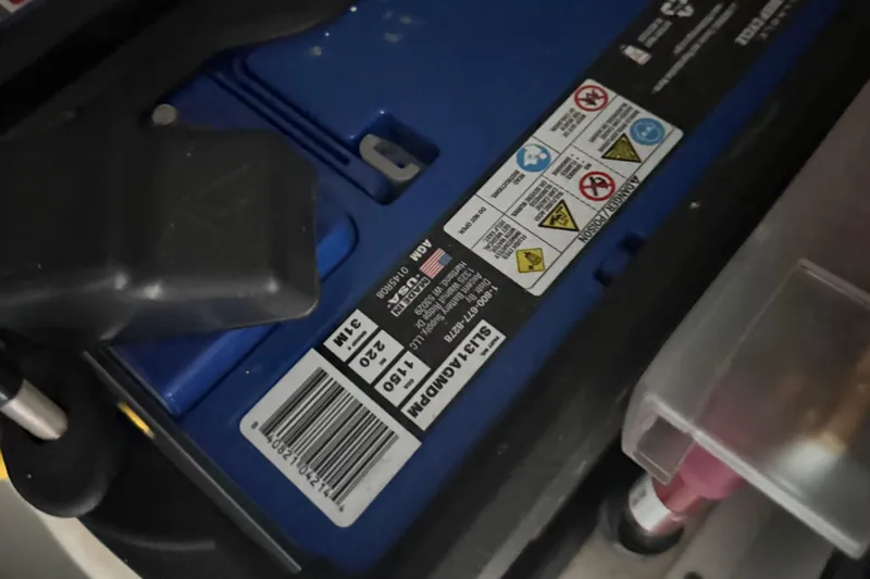 Kailani II Yacht Photos Pics Battery compartment of 2023 Cruisers Yachts 34 GLS OB with safety labels and barcode.