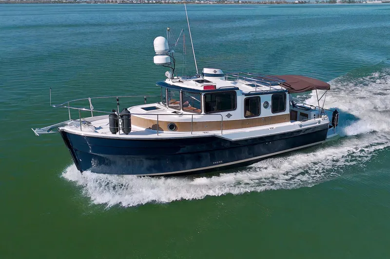  Yacht Photos Pics 2011 Ranger Tugs R-29 cruising on open water, showcasing sleek design and performance.