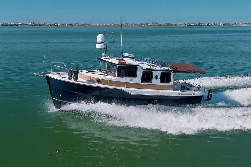  Yacht Photos Pics 2011 Ranger Tugs R-29 cruising on open water, showcasing sleek design and performance.