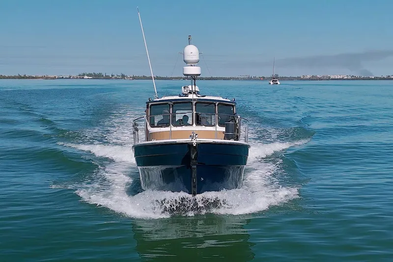  Yacht Photos Pics 2011 Ranger Tugs R-29 cruising on open water, front view.