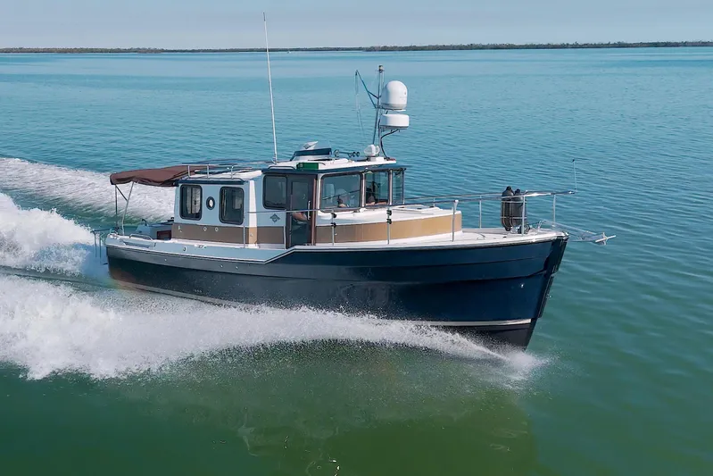  Yacht Photos Pics 2011 Ranger Tugs R-29 cruising on open water, showcasing sleek design and performance.
