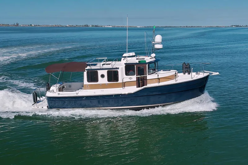  Yacht Photos Pics 2011 Ranger Tugs R-29 cruising on open water, side view.