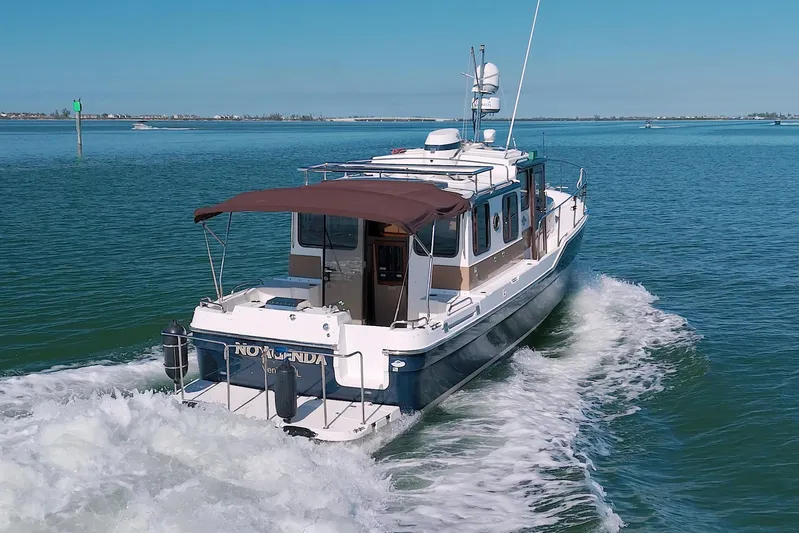  Yacht Photos Pics 2011 Ranger Tugs R-29 cruising on open water, rear view.