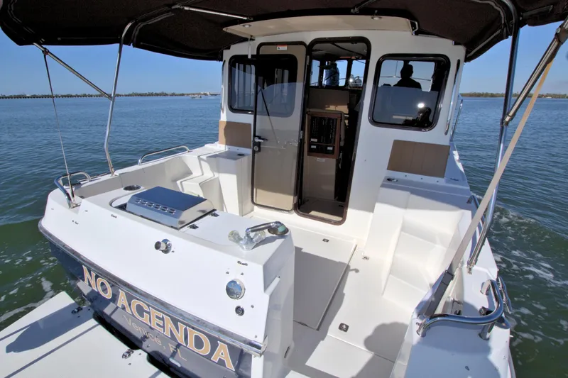  Yacht Photos Pics 2011 Ranger Tugs R-29 boat with spacious deck and cabin on calm water.
