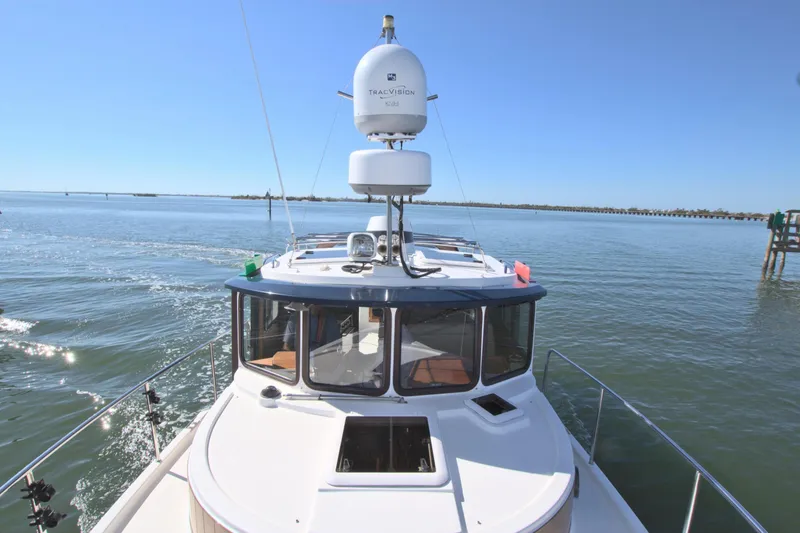  Yacht Photos Pics 2011 Ranger Tugs R-29 boat cruising on calm waters under clear blue sky.