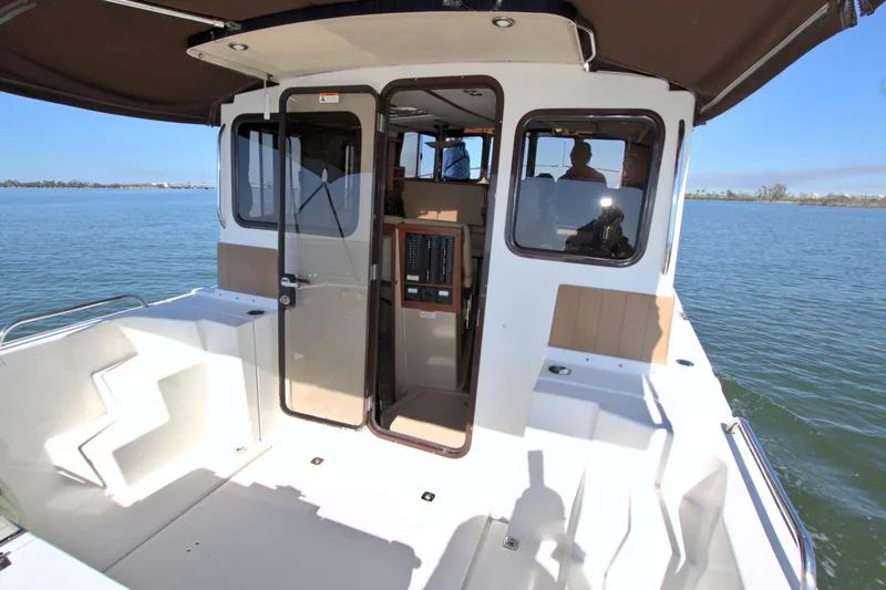  Yacht Photos Pics 2011 Ranger Tugs R-29 boat with open cabin door on calm water.