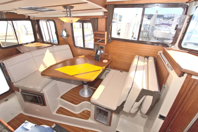  Yacht Photos Pics 2011 Ranger Tugs R-29 interior with dining area, wood accents, and large windows.