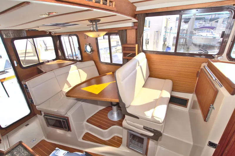  Yacht Photos Pics Interior of 2011 Ranger Tugs R-29 boat with cozy seating and dining area.