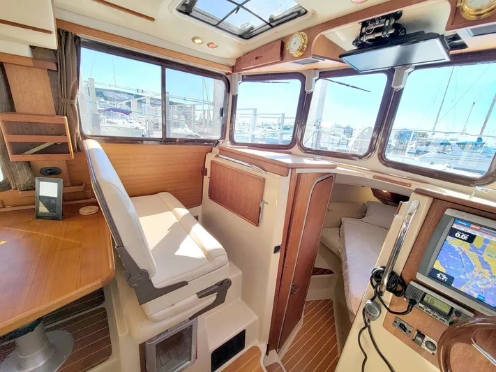  Yacht Photos Pics Interior of 2011 Ranger Tugs R-29 boat with navigation equipment and seating area.