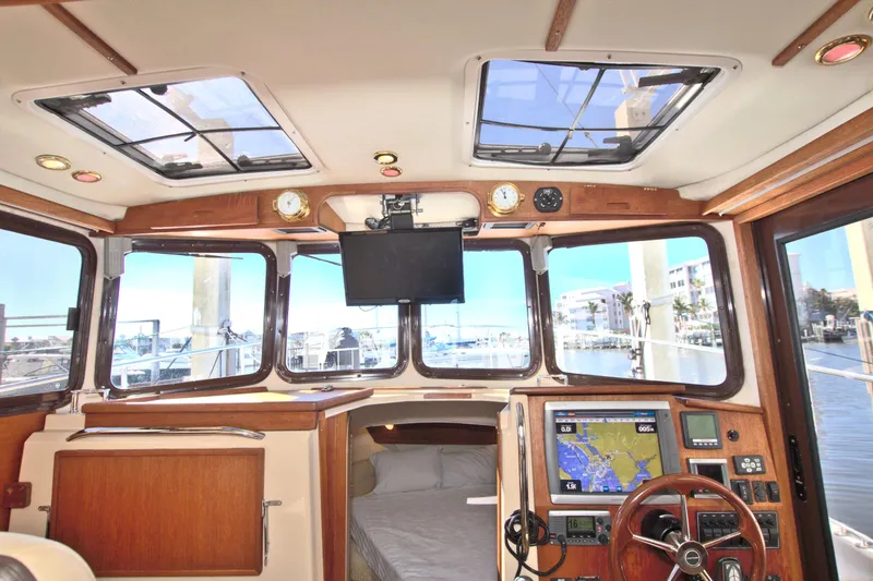  Yacht Photos Pics Interior view of 2011 Ranger Tugs R-29 boat with navigation equipment and windows.