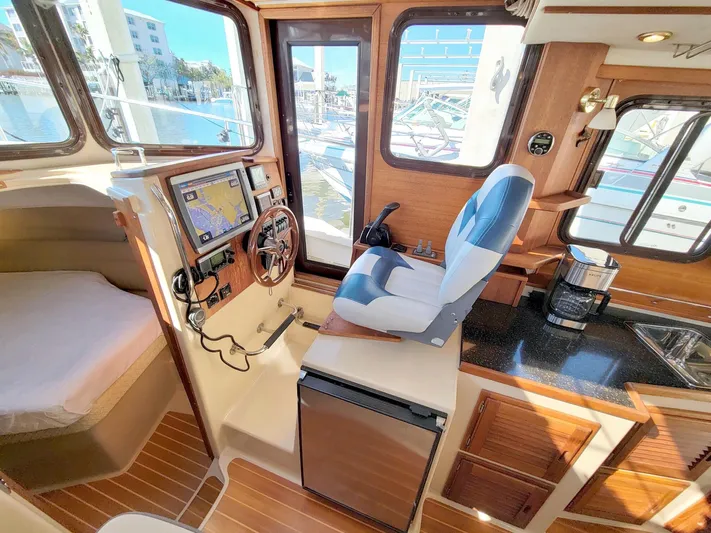  Yacht Photos Pics Interior of 2011 Ranger Tugs R-29 boat with helm, seating, and navigation equipment.