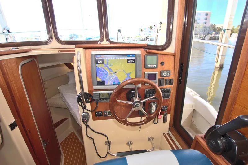  Yacht Photos Pics 2011 Ranger Tugs R-29 helm with navigation equipment and wooden steering wheel.