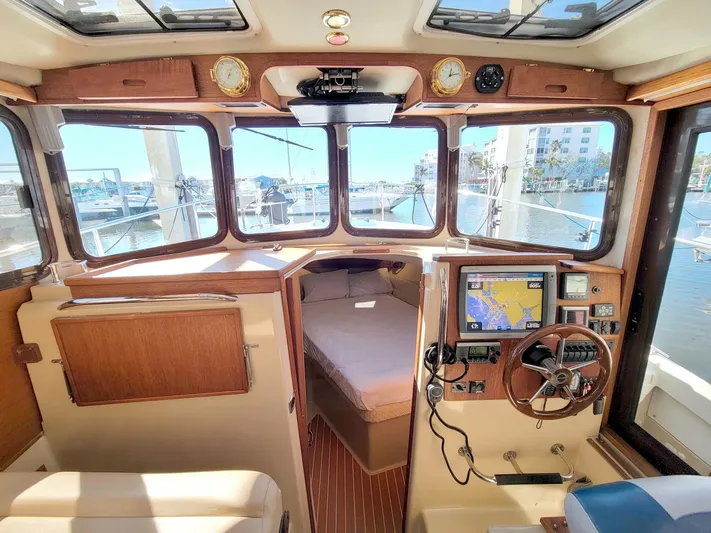  Yacht Photos Pics 2011 Ranger Tugs R-29 boat interior with navigation equipment and cozy cabin view.