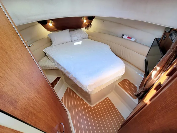  Yacht Photos Pics 2011 Ranger Tugs R-29 cabin interior with bed, wood flooring, and ambient lighting.