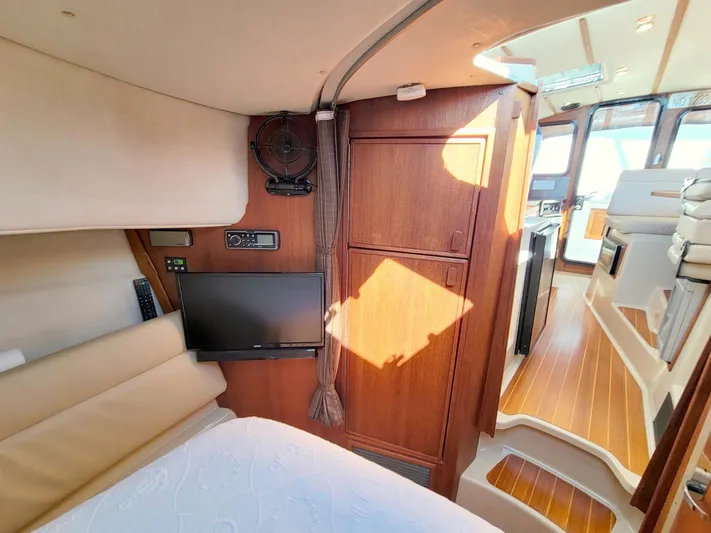  Yacht Photos Pics 2011 Ranger Tugs R-29 interior with wood finish, TV, and cozy cabin space.