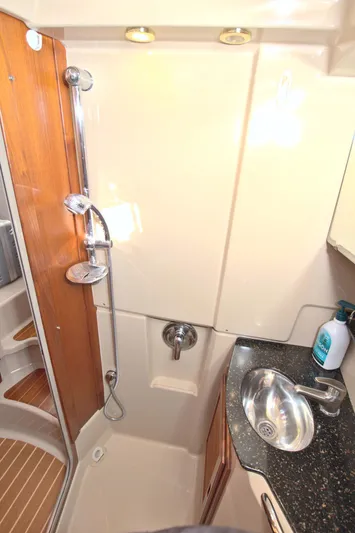  Yacht Photos Pics 2011 Ranger Tugs R-29 bathroom with shower, sink, and wooden accents.
