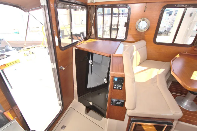  Yacht Photos Pics 2011 Ranger Tugs R-29 interior with seating, wood finish, and windows.