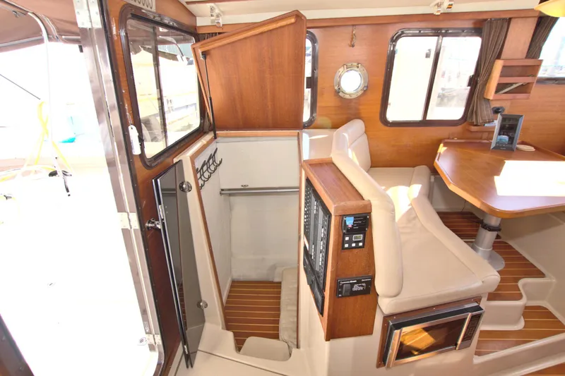  Yacht Photos Pics Interior of 2011 Ranger Tugs R-29 boat with wood accents and seating area.