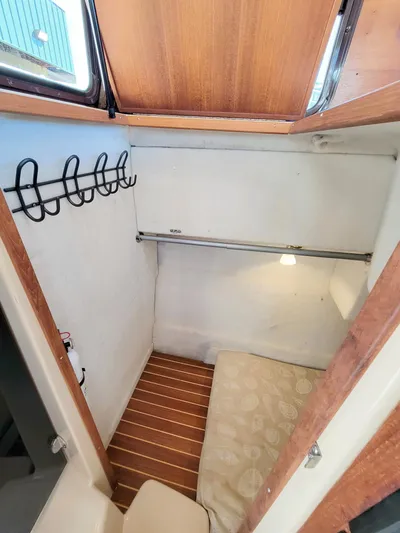  Yacht Photos Pics 2011 Ranger Tugs R-29 interior cabin with wooden accents and cozy sleeping area.