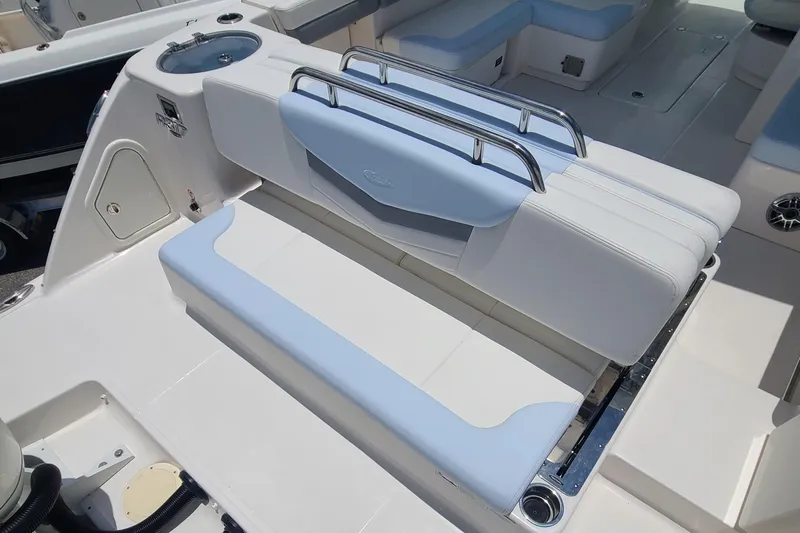  Yacht Photos Pics 2024 Robalo R317 Dual Console boat interior with light blue and white seating.