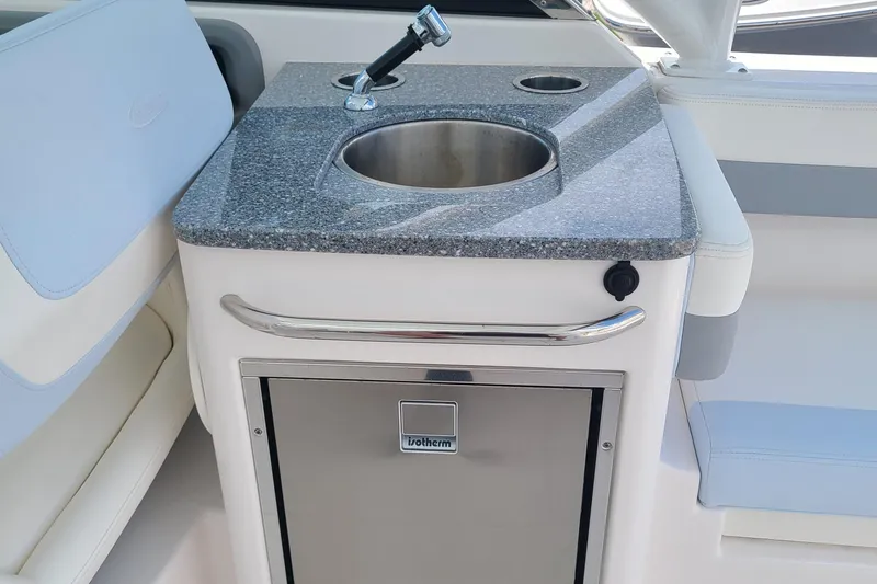  Yacht Photos Pics 2024 Robalo R317 Dual Console boat kitchenette with sink and storage.