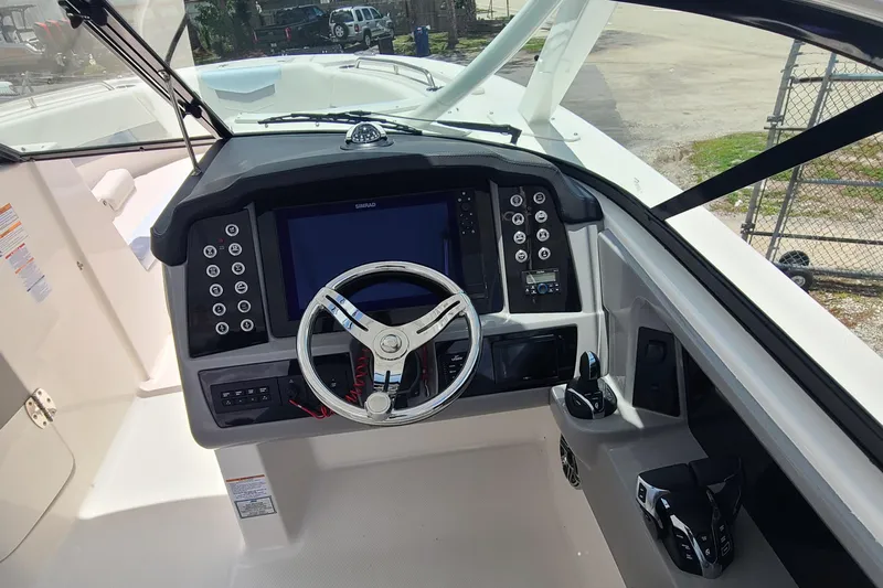  Yacht Photos Pics 2024 Robalo R317 Dual Console boat dashboard with steering wheel and control panel.