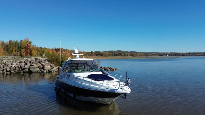  Yacht Photos Pics 2008 Cruisers Yachts 460 Express on calm lake with autumn trees in background.