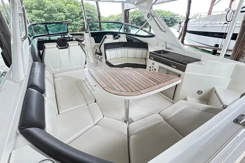 2018 Sea Ray 350 Slx @ Cancun Yacht Photos Pics 2018 Sea Ray SLX 350 interior with luxurious seating and wooden table.