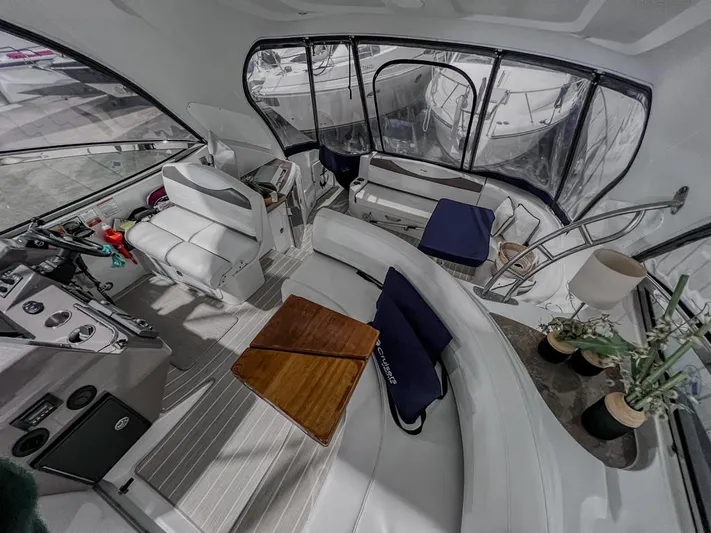  Yacht Photos Pics Interior of 2008 Cruisers Yachts 460 Express with white seating and wooden table.