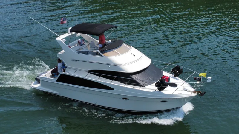  Yacht Photos Pics 2004 Carver 360 Sport Sedan cruising on water, featuring sleek design and spacious deck.