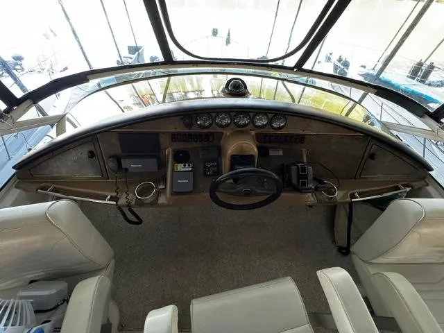  Yacht Photos Pics 2004 Carver 360 Sport Sedan helm with steering wheel, gauges, and controls.