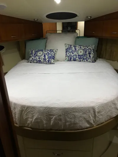  Yacht Photos Pics Luxurious bedroom interior of 2004 Carver 360 Sport Sedan with elegant bedding and wood cabinetry.