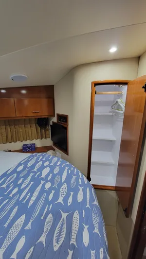  Yacht Photos Pics Interior of 2004 Carver 360 Sport Sedan with bed, closet, and wooden cabinetry.