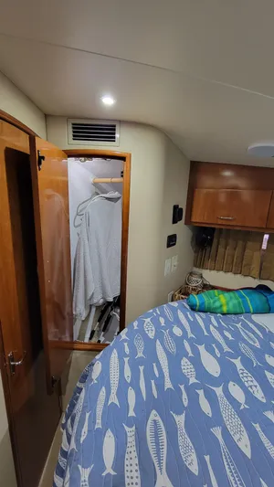  Yacht Photos Pics Interior of 2004 Carver 360 Sport Sedan with closet and fish-patterned bedspread.