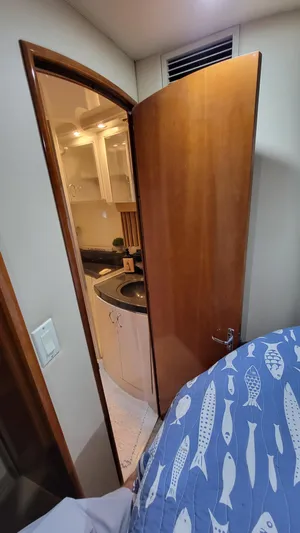  Yacht Photos Pics Interior view of 2004 Carver 360 Sport Sedan, showing a partially open door to a compact bathroom.