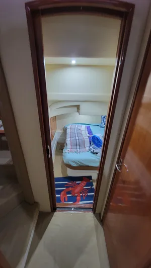  Yacht Photos Pics Interior cabin of a 2004 Carver 360 Sport Sedan with cozy bedding and nautical decor.