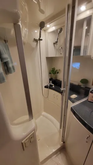  Yacht Photos Pics 2004 Carver 360 Sport Sedan bathroom with shower, modern fixtures, and sleek cabinetry.