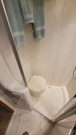  Yacht Photos Pics Compact bathroom in 2004 Carver 360 Sport Sedan with shower and toilet.