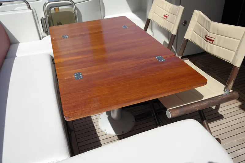 Fantasia 04 Yacht Photos Pics Luxury Azimut 43S 2009 yacht interior with wooden table and cushioned seating.