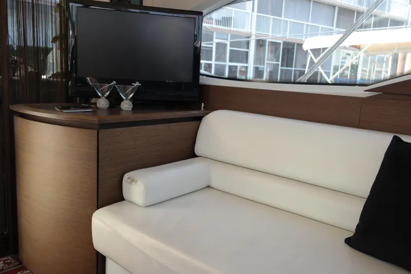 Fantasia 04 Yacht Photos Pics Interior of 2009 Azimut 43S yacht with white sofa and TV.