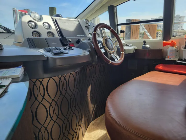 Fantasia 04 Yacht Photos Pics Interior of 2009 Azimut 43S yacht cockpit with steering wheel and control panel.