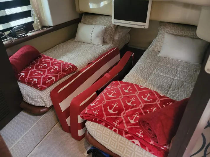 Fantasia 04 Yacht Photos Pics 2009 Azimut 43S yacht cabin with twin beds, anchor-themed blankets, and a wall-mounted TV.